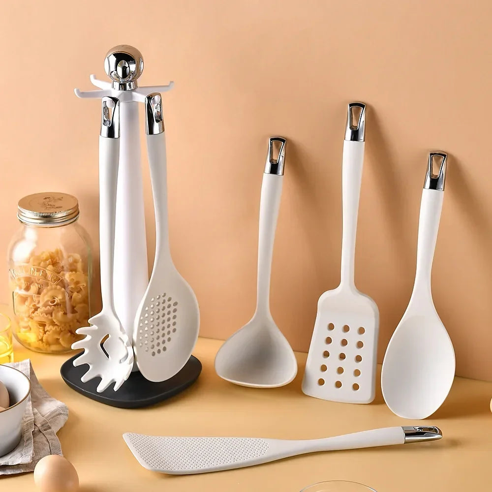 7-Piece Silicone Kitchen Utensils Set with 360° Rotating Countertop Holder – White silicone heads and handles with silver-tone stainless steel hanging hooks/end caps. Heat-Resistant, Dishwasher Safe