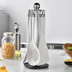 7-Piece Silicone Kitchen Utensils Set with 360° Rotating Countertop Holder – White silicone heads and handles with silver-tone stainless steel hanging hooks/end caps. Heat-Resistant, Dishwasher Safe