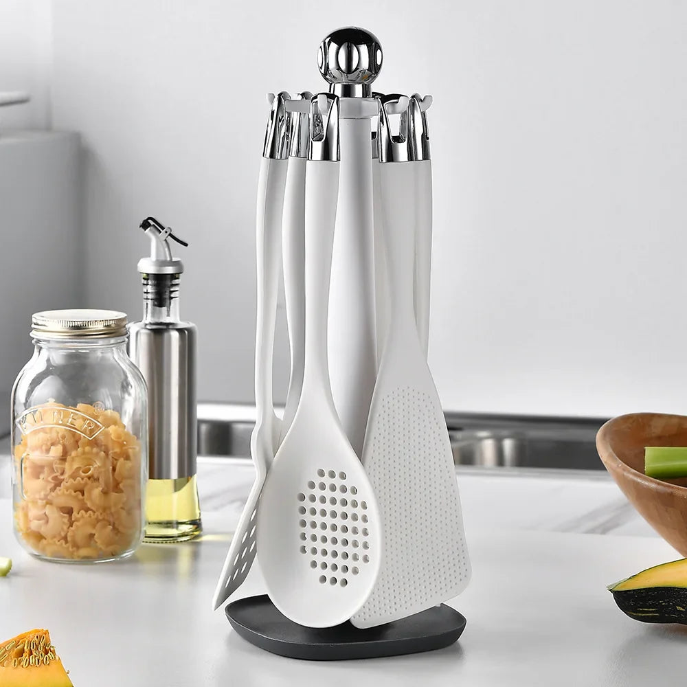 7-Piece Silicone Kitchen Utensils Set with 360° Rotating Countertop Holder – White silicone heads and handles with silver-tone stainless steel hanging hooks/end caps. Heat-Resistant, Dishwasher Safe